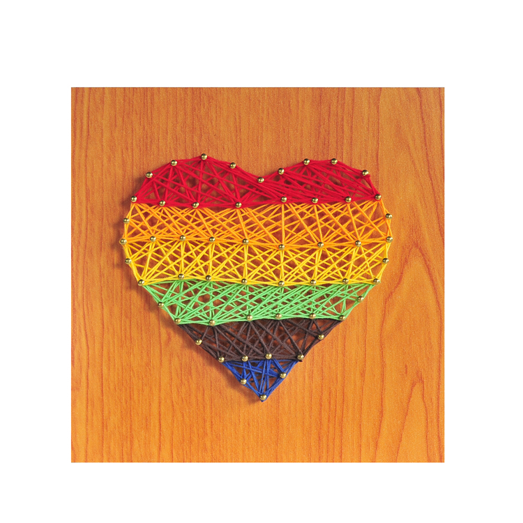 String art heart detail with bright red thread